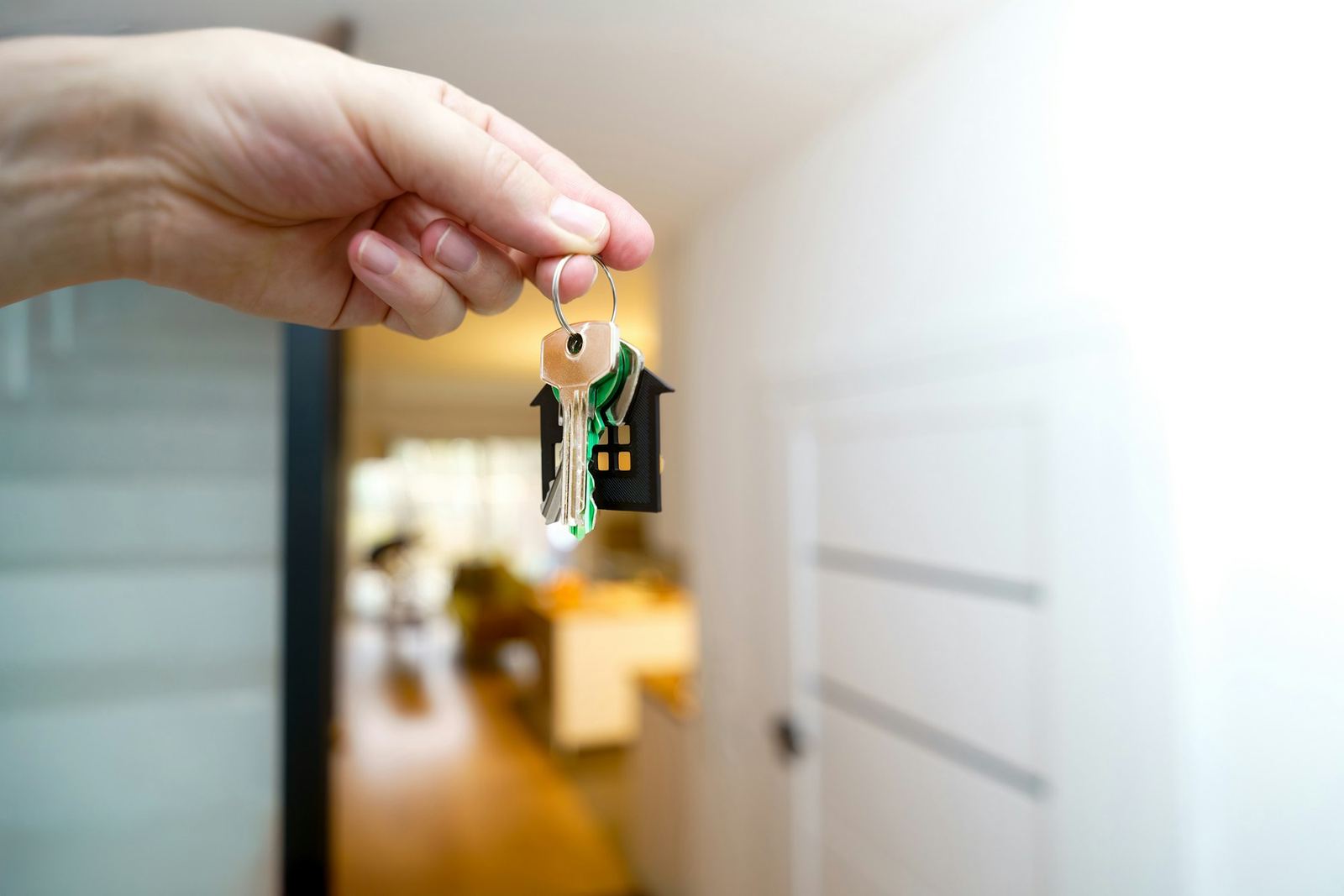 House keys held in a bright hallway — representing property handover